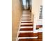 Staircase with hardwood steps and white risers at 100 W Myrtle St, Howey In The Hills, FL 34737