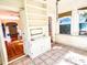 Sunroom features built-in shelving and tile flooring at 100 W Myrtle St, Howey In The Hills, FL 34737