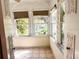 Sunroom with tile floors and views of the backyard at 100 W Myrtle St, Howey In The Hills, FL 34737