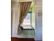 Cozy window seat with patterned curtains in bedroom at 100 W Myrtle St, Howey In The Hills, FL 34737