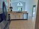 Kitchen with stainless steel appliances and view to Gathering room at 1040 Soaring Eagle Ln, Kissimmee, FL 34746