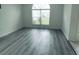 Living room with gray vinyl flooring and large window at 1040 Soaring Eagle Ln, Kissimmee, FL 34746