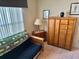 Bedroom with a futon, wardrobe, and nightstand at 1270 Addison Ave, The Villages, FL 32162