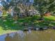 Aerial view of house, showcasing backyard and pond views at 1310 Moray Ct, Leesburg, FL 34788
