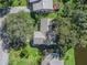 Aerial view of a single-Gathering home with a large backyard and surrounding trees at 1310 Moray Ct, Leesburg, FL 34788