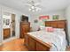 Bedroom with ensuite bathroom and wood floors at 1310 Moray Ct, Leesburg, FL 34788