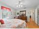 Bedroom with ensuite bathroom and wood floors at 1310 Moray Ct, Leesburg, FL 34788