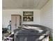 Hot tub on covered patio with storage and garden tools at 1310 Moray Ct, Leesburg, FL 34788