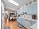 Updated kitchen features light blue cabinets and white countertops at 1310 Moray Ct, Leesburg, FL 34788