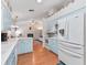 Modern kitchen with white appliances and light blue cabinets at 1310 Moray Ct, Leesburg, FL 34788