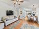 Living room with hardwood floors and view of kitchen at 1310 Moray Ct, Leesburg, FL 34788
