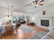 Living room with fireplace, hardwood floors, and comfy seating at 1310 Moray Ct, Leesburg, FL 34788