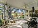 Spacious covered patio with pond view and comfortable seating at 1310 Moray Ct, Leesburg, FL 34788
