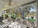 Covered patio overlooking a pond with fountain and lush landscape at 1310 Moray Ct, Leesburg, FL 34788