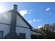 Chimney and roofline detail against a bright sky at 13234 S Carolina Ave, Astatula, FL 34705