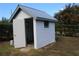 Small shed with white paint and metal roof at 13234 S Carolina Ave, Astatula, FL 34705