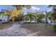 House with a large yard, and tropical landscaping at 13536 Se Sunset Harbor Rd, Weirsdale, FL 32195