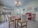 Dining area with a table, chandelier, and an adjacent kitchen at 1500 Alexa Pl, The Villages, FL 32162