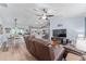 Spacious living room with a brown sectional sofa and wood floors at 1679 Bluffton Rd, The Villages, FL 32162