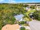 Aerial view showcasing the home, pool, and surrounding neighborhood with views of distant buildings at 240 Citrus Wood Ct, Davenport, FL 33837