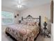 Bedroom with decorative metal headboard, carpeted floors, and ceiling fan at 240 Citrus Wood Ct, Davenport, FL 33837