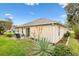 View of the home's backyard, featuring a patio and well-manicured lawn at 2469 Morven Park Way, The Villages, FL 32162