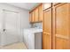 Laundry room with washer, dryer, and wood cabinets at 2469 Morven Park Way, The Villages, FL 32162