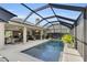 Inviting pool area with screened enclosure and spacious patio at 2717 Dunham Dr, The Villages, FL 32163