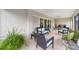 Screened porch with wicker furniture, ceiling fans, and sliding glass doors at 3766 Causey Ct, The Villages, FL 32163