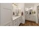 Bright bathroom with white cabinetry, a dual vanity, and modern fixtures at 3766 Causey Ct, The Villages, FL 32163