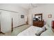 Bedroom featuring a four-poster bed, closet, and carpeted floors at 3766 Causey Ct, The Villages, FL 32163