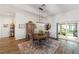 Dining area with a round table, sliding glass doors leading to the backyard, and an open-plan layout at 3766 Causey Ct, The Villages, FL 32163