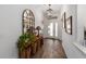 Welcoming foyer with decorative mirror, console table, and wood-look tile flooring at 3766 Causey Ct, The Villages, FL 32163