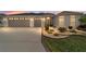 Charming home exterior at dusk, featuring warm lighting and lush landscaping at 3766 Causey Ct, The Villages, FL 32163