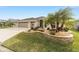 Attractive curb appeal with palm trees, a two-car garage, and a well-maintained lawn at 3766 Causey Ct, The Villages, FL 32163