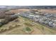 An aerial perspective of a golf course with a pond and nearby homes at 3766 Causey Ct, The Villages, FL 32163