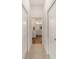 Hallway leading to a bathroom, featuring white doors and carpeted flooring at 3766 Causey Ct, The Villages, FL 32163