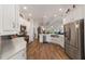 Spacious kitchen with white cabinets, stainless steel appliances, and ample counter space at 3766 Causey Ct, The Villages, FL 32163