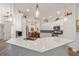 Bright, updated kitchen featuring white cabinetry, stainless steel appliances, and an island with seating at 3766 Causey Ct, The Villages, FL 32163
