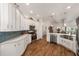 Well-appointed kitchen with plenty of counter space, white cabinets, and a breakfast bar at 3766 Causey Ct, The Villages, FL 32163