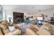 Cozy living room featuring leather furniture, a built-in entertainment center, and open concept layout at 3766 Causey Ct, The Villages, FL 32163