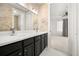Bathroom with double vanity, dark cabinetry, and a view into bedroom at 39539 Harbor Hills Blvd, Lady Lake, FL 32159
