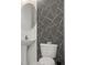 Small bathroom with pedestal sink and geometric patterned wall at 39539 Harbor Hills Blvd, Lady Lake, FL 32159