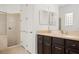 Bathroom with a shower, dark brown vanity, and linen closet at 39539 Harbor Hills Blvd, Lady Lake, FL 32159