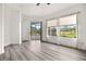 Bedroom with wood-look flooring, access to patio, and golf course view at 39539 Harbor Hills Blvd, Lady Lake, FL 32159