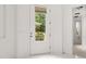 Bright entryway with white walls and tile floors, leading to other rooms at 39539 Harbor Hills Blvd, Lady Lake, FL 32159