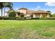 Exterior view of a charming house with a circular turret and lush landscaping at 39539 Harbor Hills Blvd, Lady Lake, FL 32159