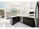 Modern kitchen with dark cabinetry, white countertops, and golf course views at 39539 Harbor Hills Blvd, Lady Lake, FL 32159