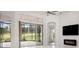 Spacious living area with sliding glass doors leading to a screened porch at 39539 Harbor Hills Blvd, Lady Lake, FL 32159