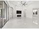 Bright living room with a fireplace, large windows, and white tile floors at 39539 Harbor Hills Blvd, Lady Lake, FL 32159